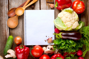 Vegetables and Spices on a Wooden Background and Paper for Notes