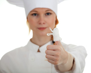 wounded female cook in white uniform and hat - cooking accident