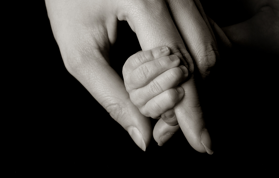 Baby holding a mothere's hand